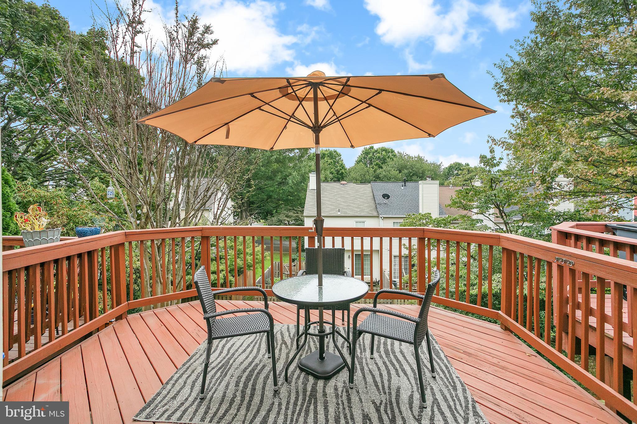 6542 Cypress Point Road Alexandria, VA 22312 - Photo 10 of 31 a view of a chair and table on the deck