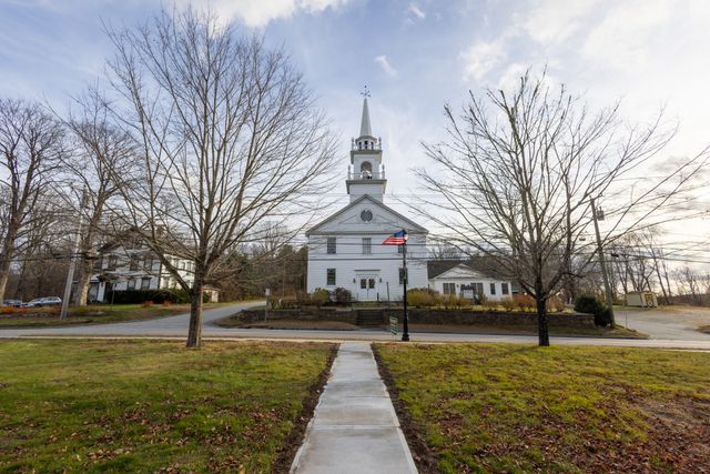 a view of a field of grass and trees