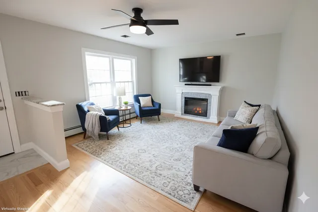 a living room with furniture a fireplace and a flat screen tv