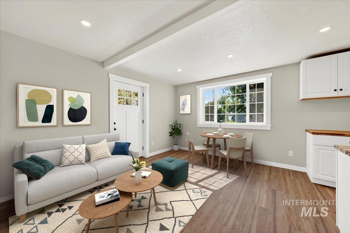 109 Parma Road Parma, ID 83660 - Photo 2 of 31 Open-concept living space featuring luxury plank flooring, recessed lighting, and a white paneled entry door