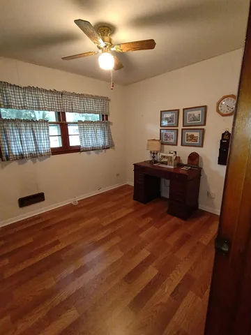 a view of a livingroom with furniture and chandelier fan