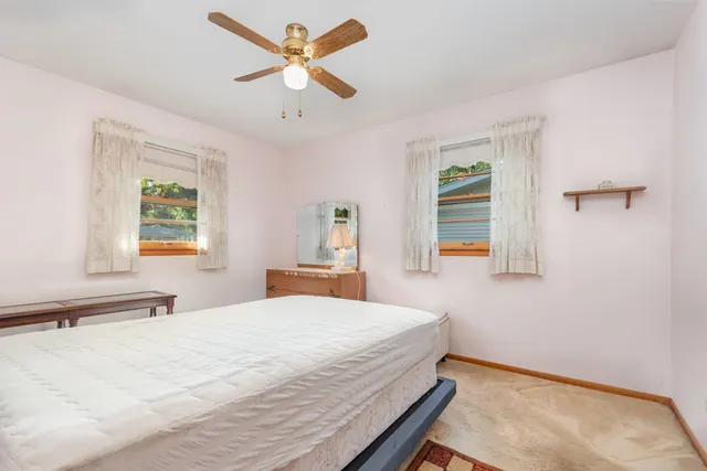 a bedroom with a large bed and a chandelier