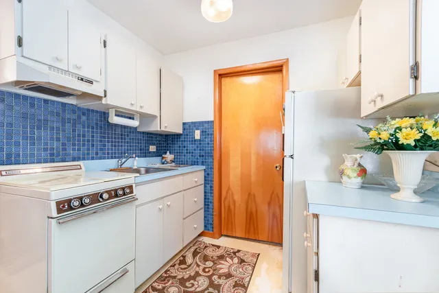 a kitchen with stainless steel appliances a stove a sink and a refrigerator