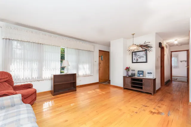a large living room with furniture and window