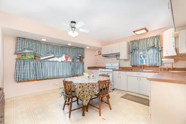 a kitchen with a sink cabinets and window