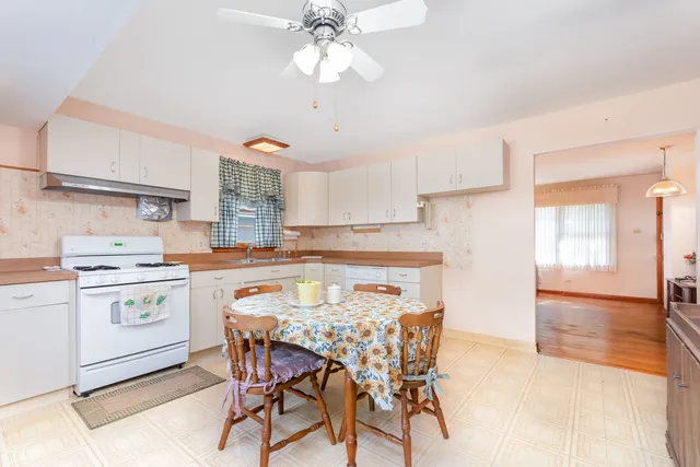a kitchen with a stove a sink and a refrigerator