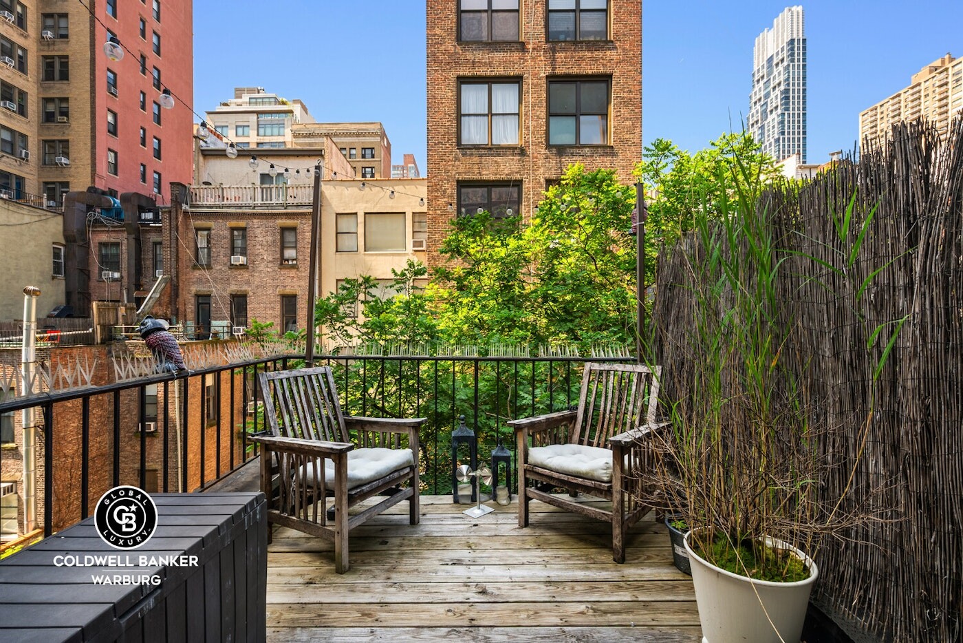 132 West 73rd Street Manhattan, NY 10023 - Photo 12 of 14 a view of a balcony with chairs and wooden fence