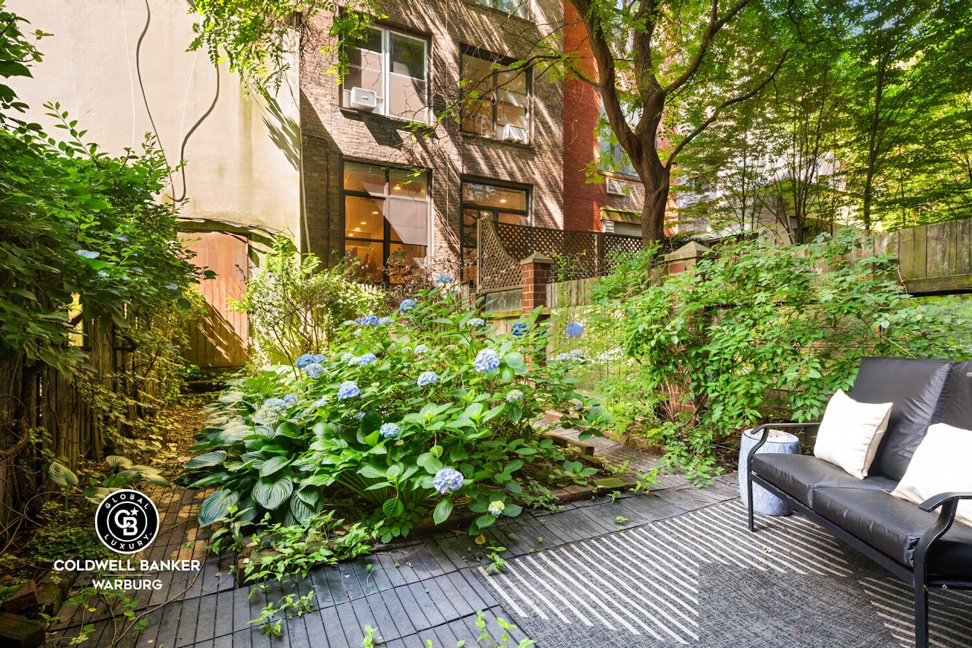 132 West 73rd Street Manhattan, NY 10023 - Photo 13 of 14 a backyard of a house with table and chairs