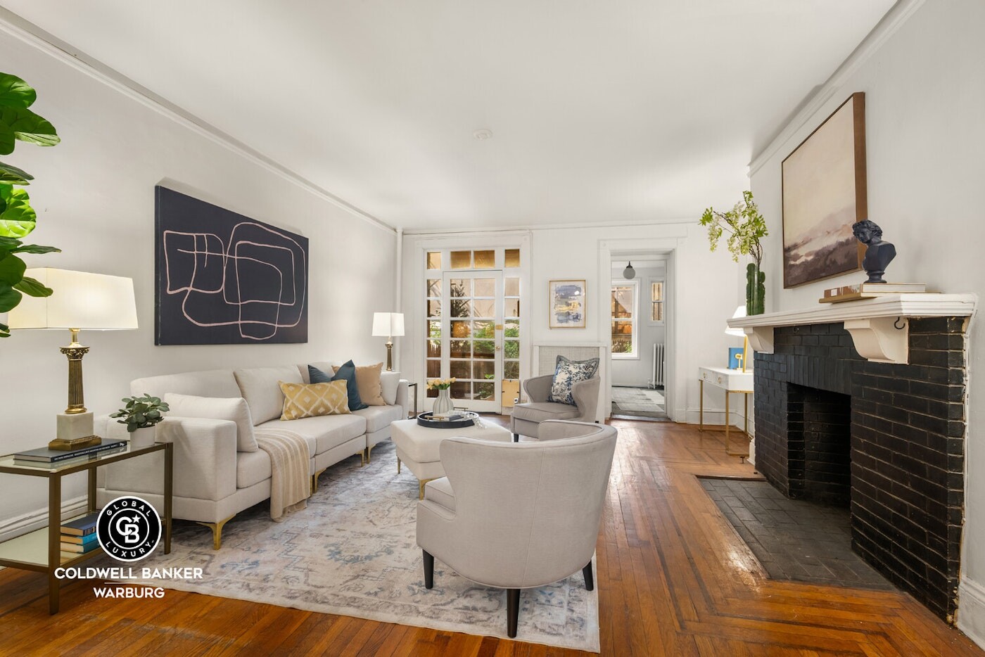 132 West 73rd Street Manhattan, NY 10023 - Photo 3 of 14 a living room with furniture a fireplace and a table