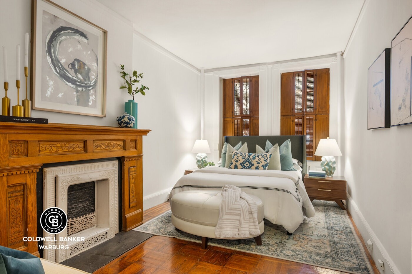 132 West 73rd Street Manhattan, NY 10023 - Photo 6 of 14 a spacious bedroom with a bed and a fireplace