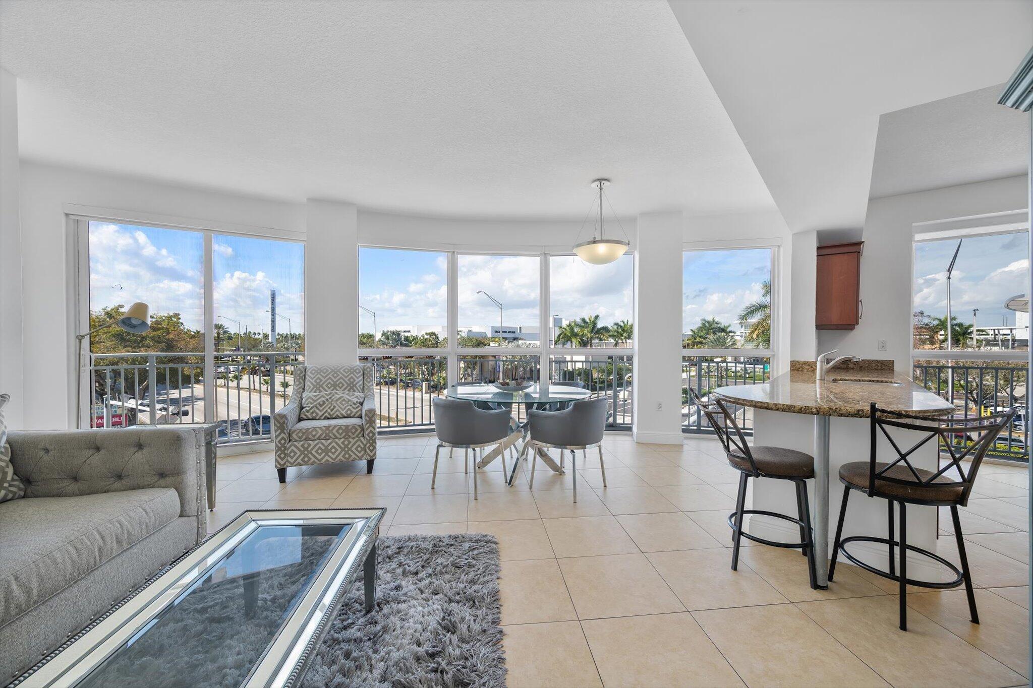 7270 Southwest 88th Street, Unit B203 Miami, FL 33156 - Photo 1 of 27 a living room with furniture and a large window