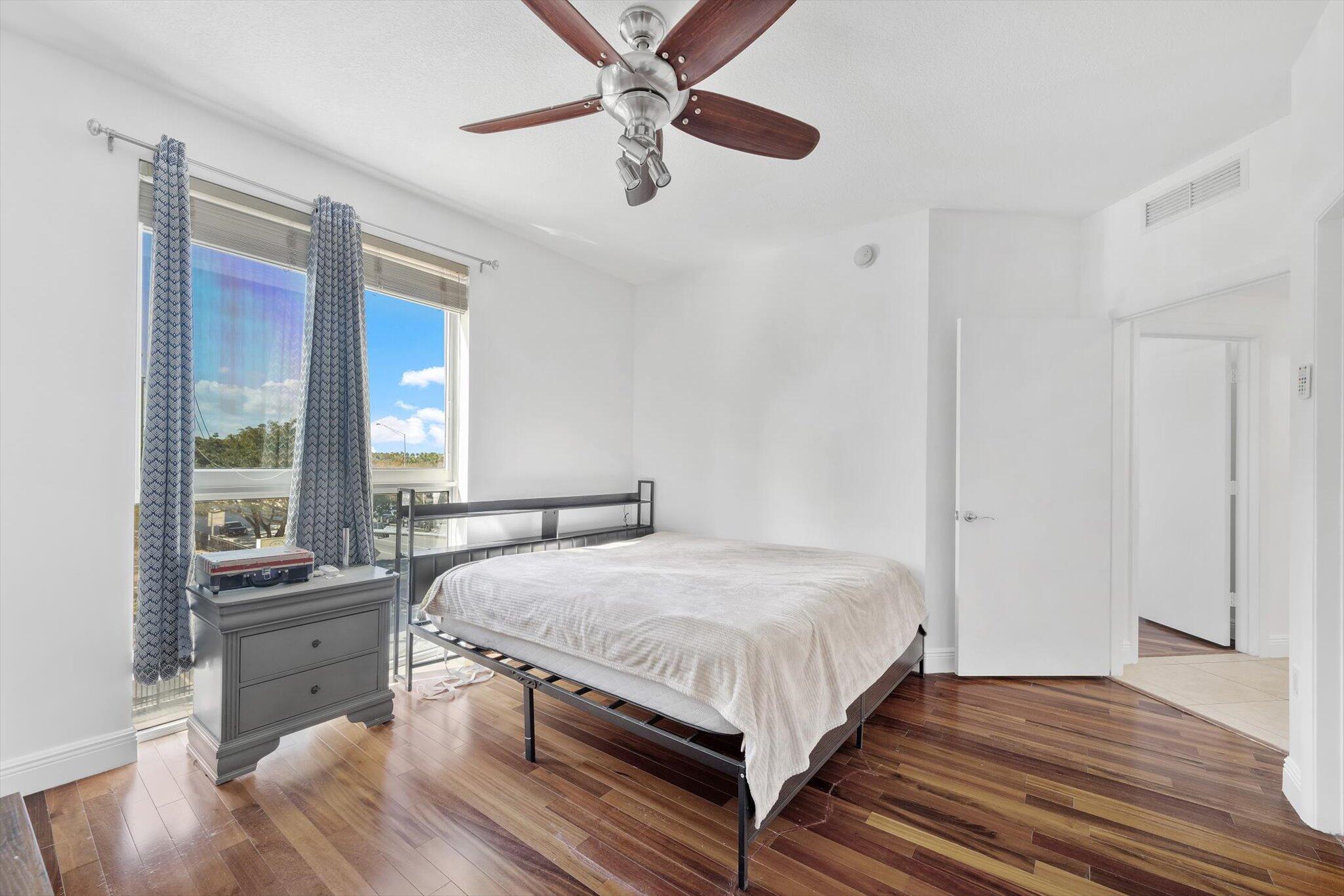7270 Southwest 88th Street, Unit B203 Miami, FL 33156 - Photo 10 of 27 a bedroom with a bed and a large window