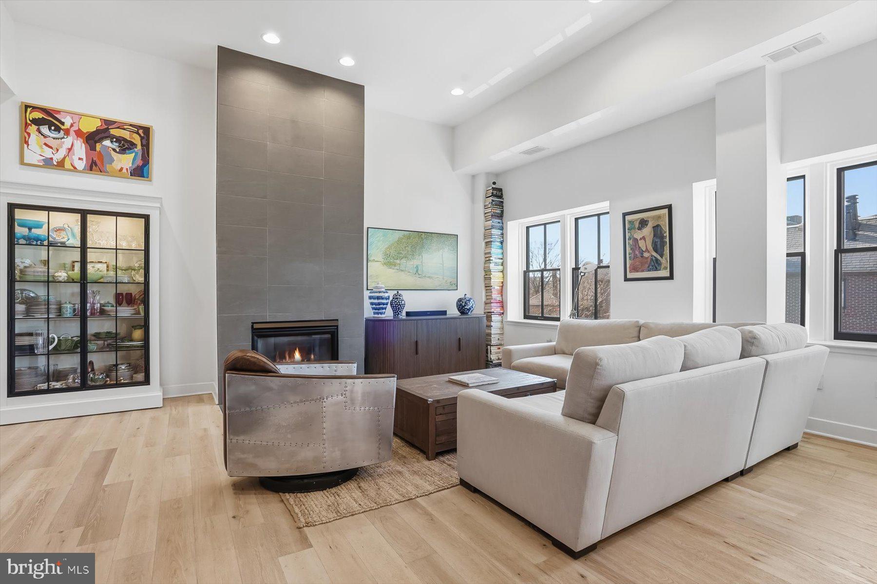 a living room with furniture and large window with wooden floor