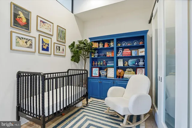 a living room with furniture and a book shelf
