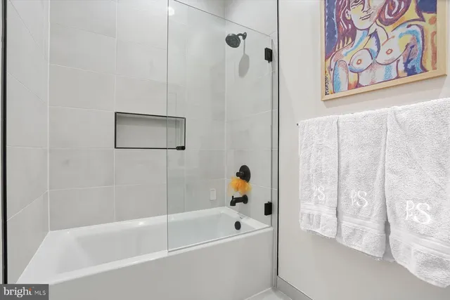 a white bath tub with a shower