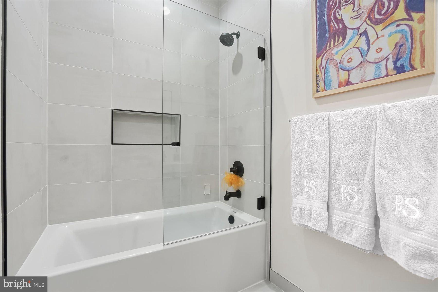 1741 Johnson Avenue Northwest, Unit 302 Washington, DC 20009 - Photo 17 of 24 a white bath tub with a shower