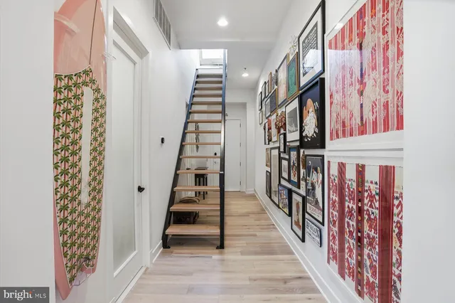 a view of entryway with wooden floor and stairs