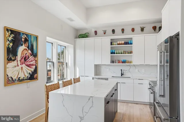 a kitchen with a sink a stove and cabinets