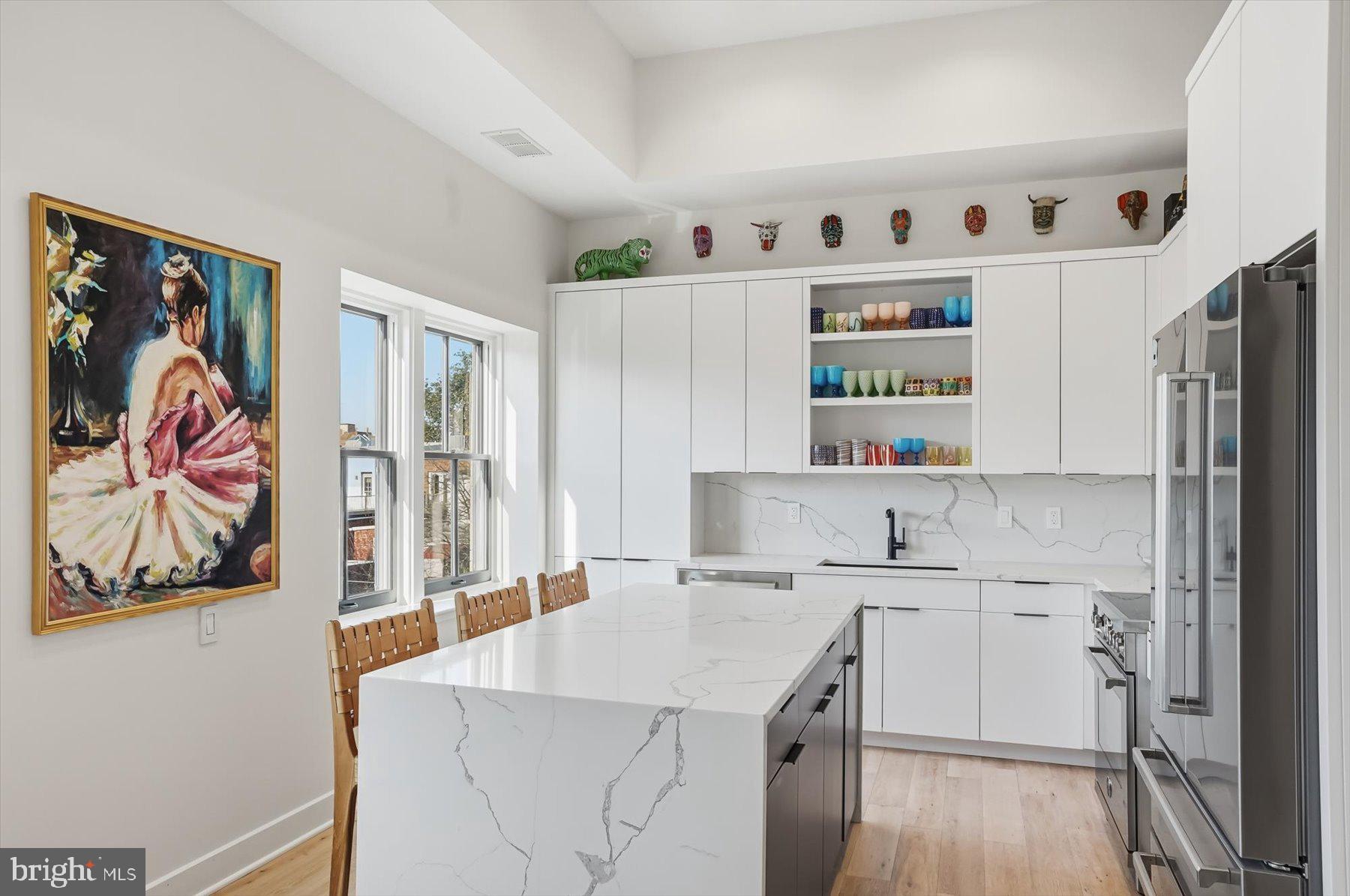 1741 Johnson Avenue Northwest, Unit 302 Washington, DC 20009 - Photo 7 of 24 a kitchen with a sink a stove and cabinets