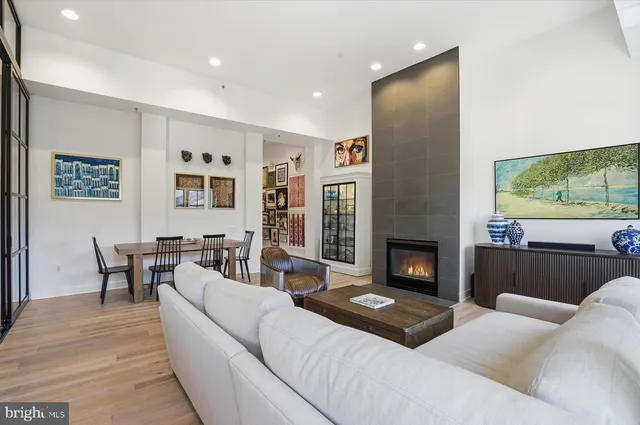 a living room with furniture a fireplace and a flat screen tv