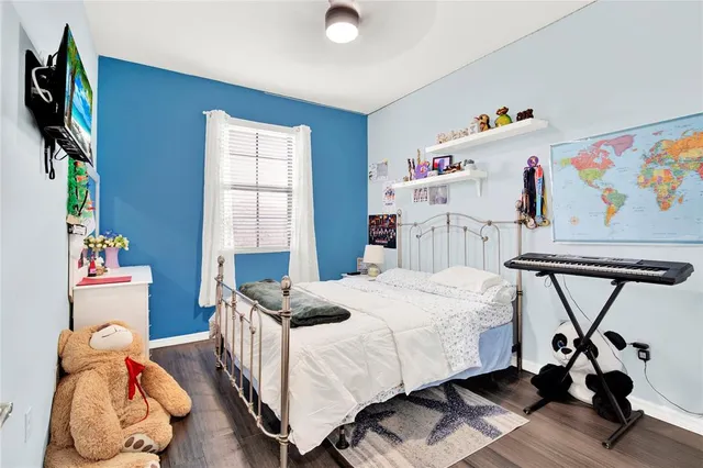 a bedroom with a bed and a window