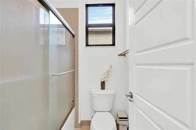 a bathroom with a toilet and a shower