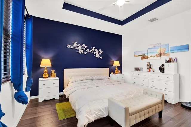 a bedroom with a bed and a chandelier