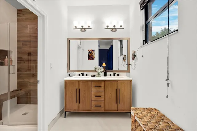 a bathroom with a double vanity sink and mirror