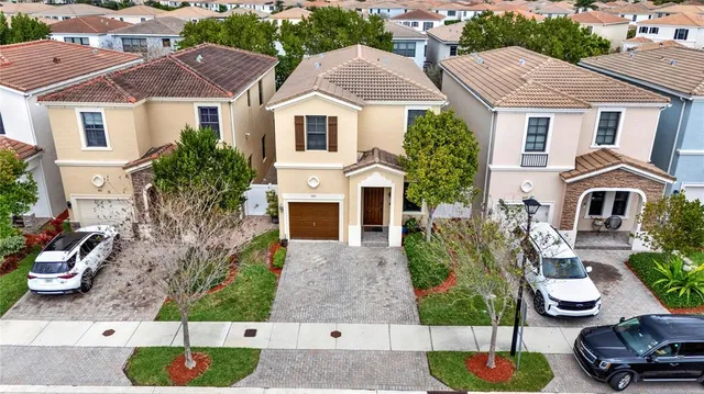 an aerial view of residential houses with yard