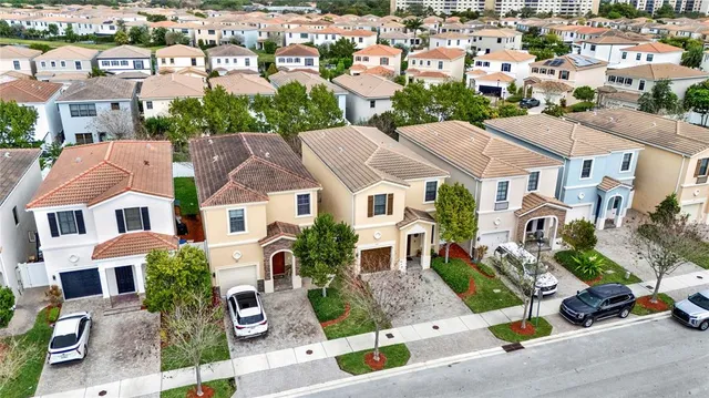 an aerial view of residential houses with outdoor space