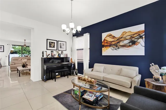 a living room with furniture a couch and a chandelier