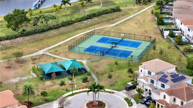 an aerial view of a house with a swimming pool and red chairs