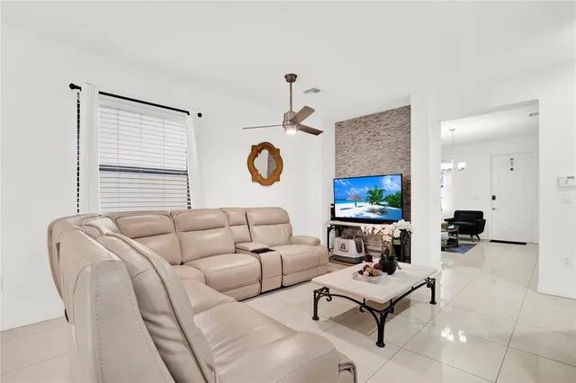 a living room with furniture a rug and a window