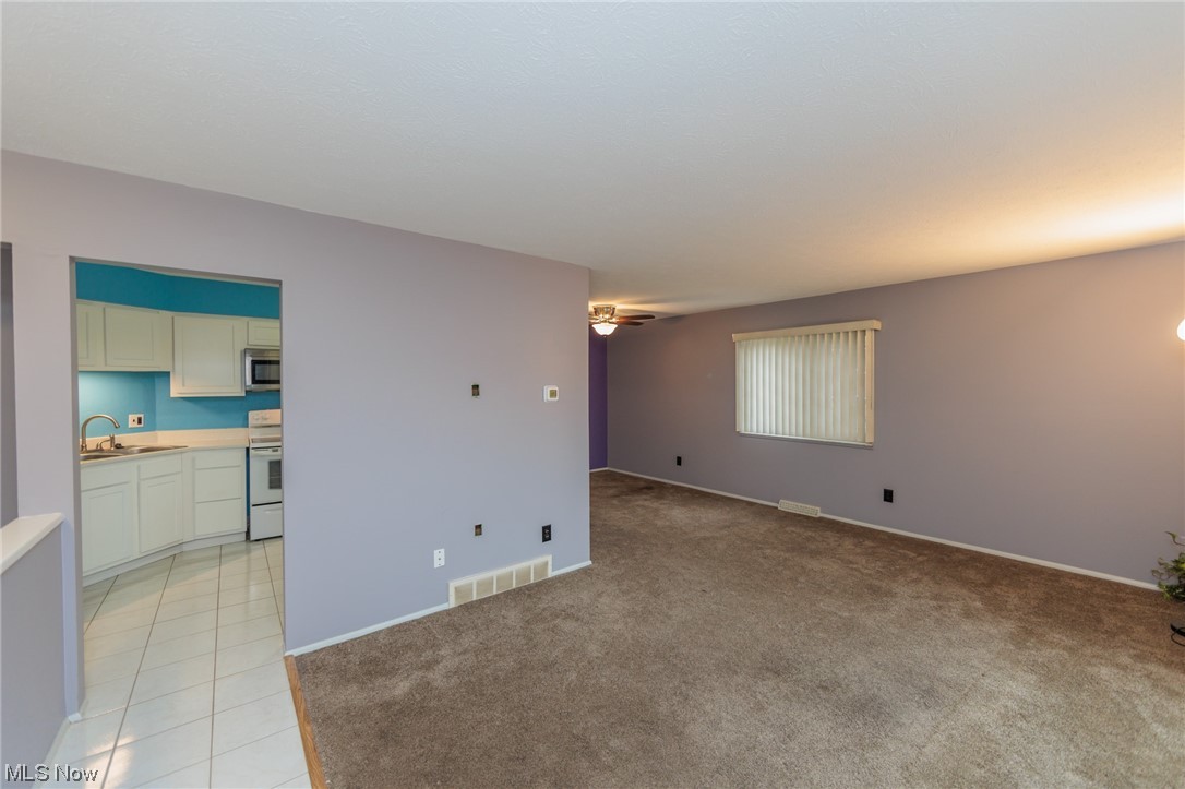 6472 State Road, Unit J19 Parma, OH 44134 - Photo 6 of 33 Tiled spare room with sink and ceiling fan