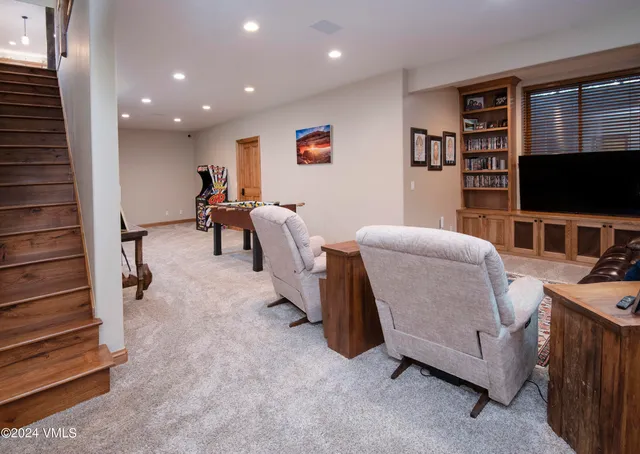 a view of a chairs and table on the wooden deck with a yard