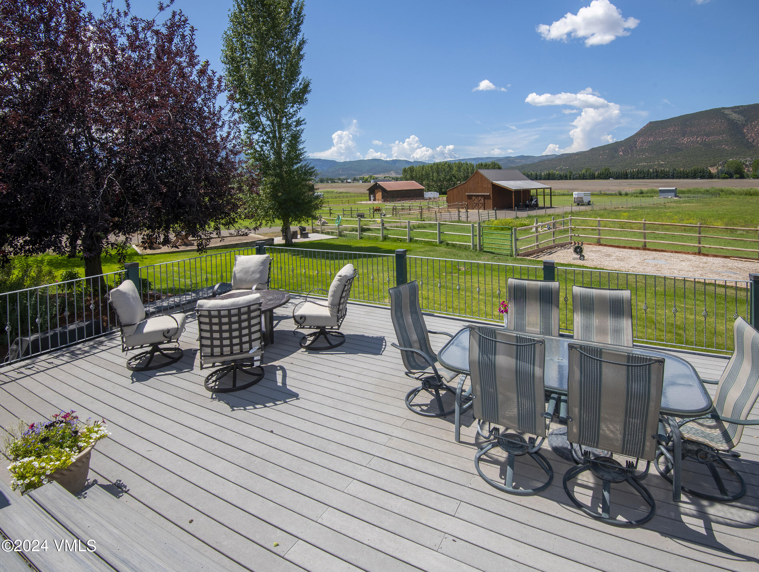 911 Mayne Street Gypsum, CO 81637 - Photo 42 of 87 a view of a chairs and table on the wooden deck with a yard