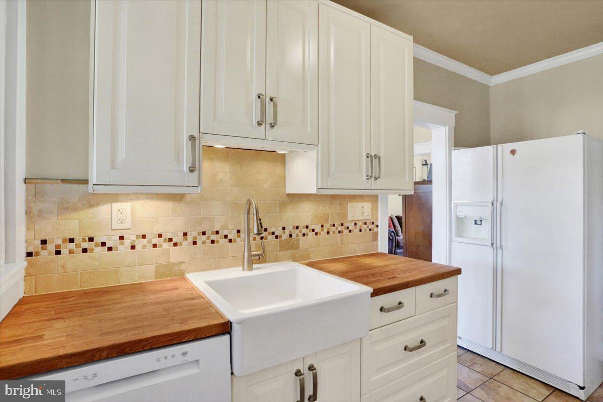 309 Sunset Road Reading, PA 19611 - Photo 11 of 31 a kitchen with granite countertop white cabinets and refrigerator