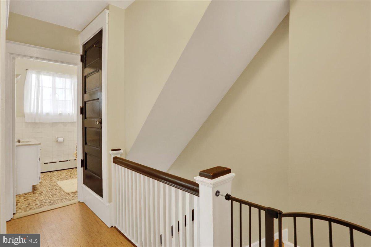 309 Sunset Road Reading, PA 19611 - Photo 13 of 31 a view of a hallway with wooden floor and staircase