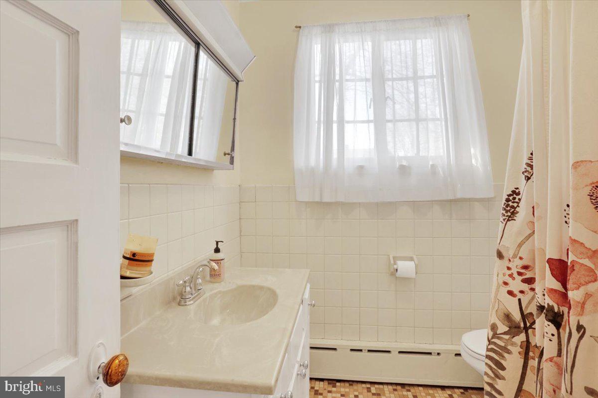 309 Sunset Road Reading, PA 19611 - Photo 17 of 31 a bathroom with mirror sink and window