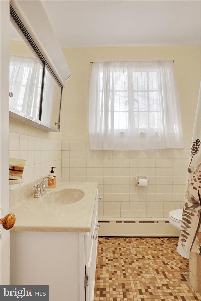 309 Sunset Road Reading, PA 19611 - Photo 18 of 31 a bathroom with a sink a toilet and a mirror