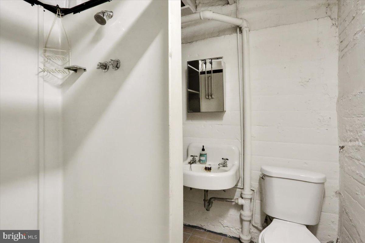 309 Sunset Road Reading, PA 19611 - Photo 24 of 31 a white toilet sitting next to a bathroom sink