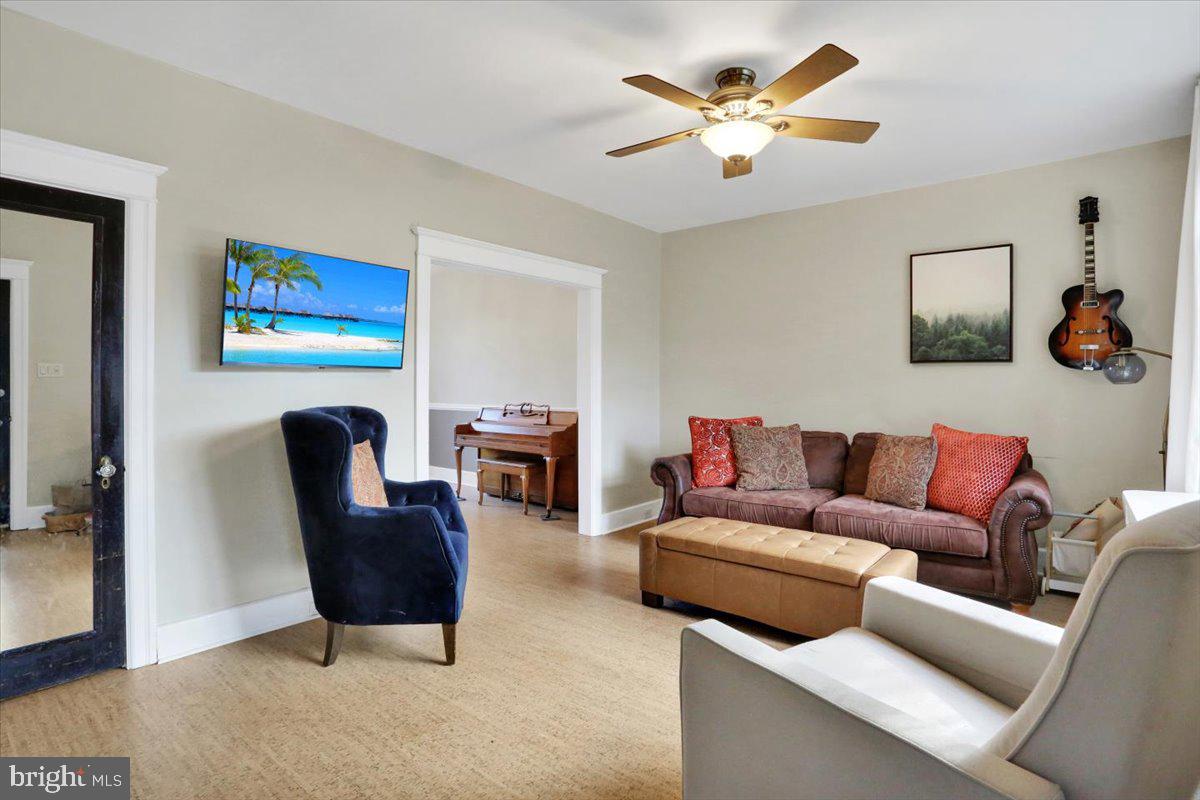 309 Sunset Road Reading, PA 19611 - Photo 5 of 31 a living room with furniture a ceiling fan and a rug