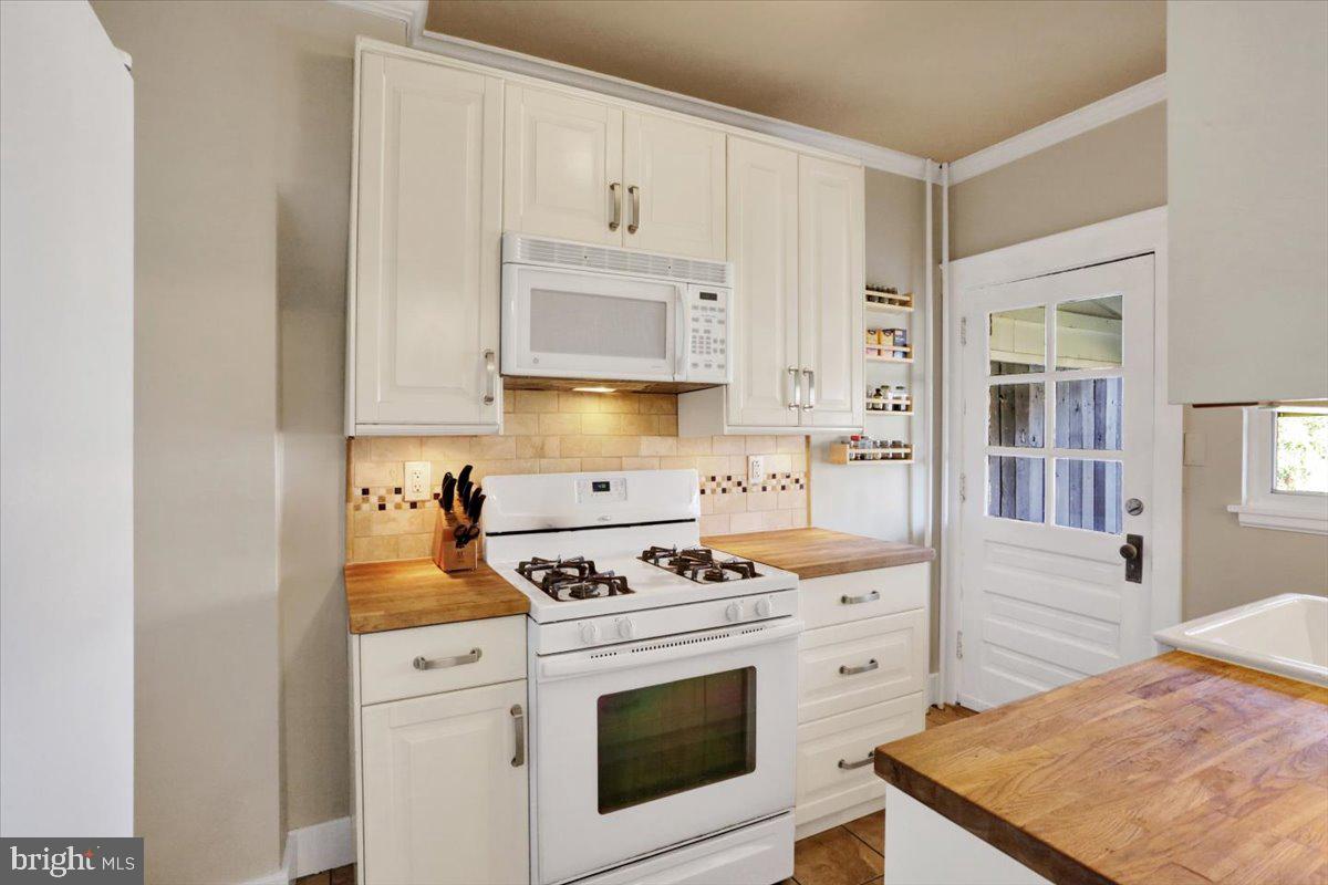 309 Sunset Road Reading, PA 19611 - Photo 8 of 31 a kitchen with stainless steel appliances white cabinets and a stove
