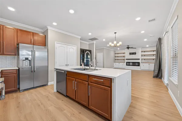 a large kitchen with stainless steel appliances kitchen island granite countertop a large counter top and stainless steel appliances