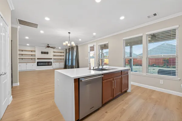 a large kitchen with kitchen island a sink stainless steel appliances and cabinets