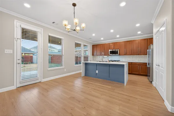 a view of kitchen with granite countertop cabinets and window