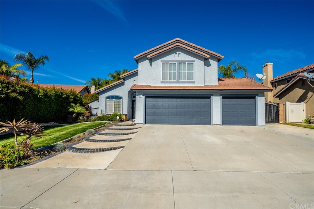 822 Langholm Way Riverside, CA 92508 - Photo 1 of 1 a front view of a house with a garden and plants