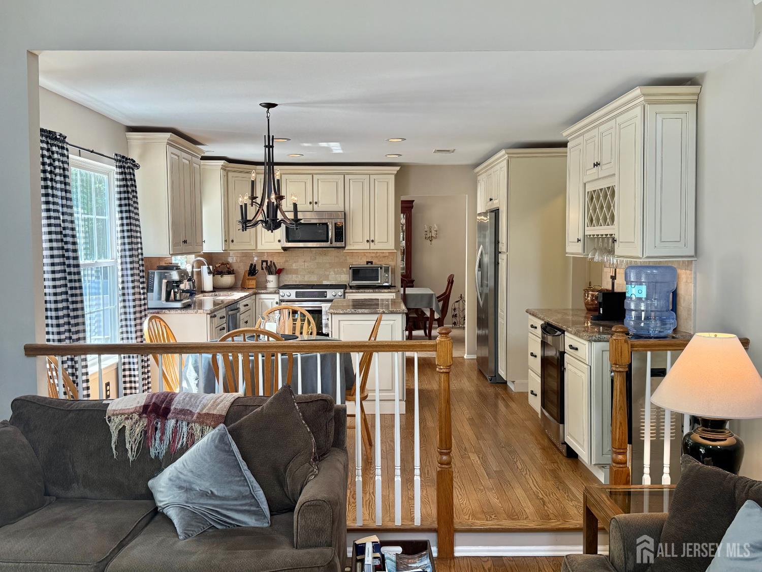 44 Diamond Lane Howell, NJ 07731 - Photo 12 of 35 a living room with furniture a rug kitchen view and a large window