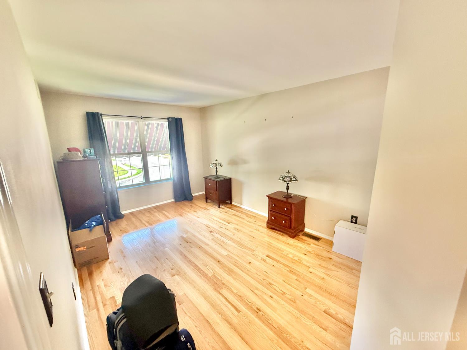 44 Diamond Lane Howell, NJ 07731 - Photo 20 of 35 a bedroom with a bed and wooden floor