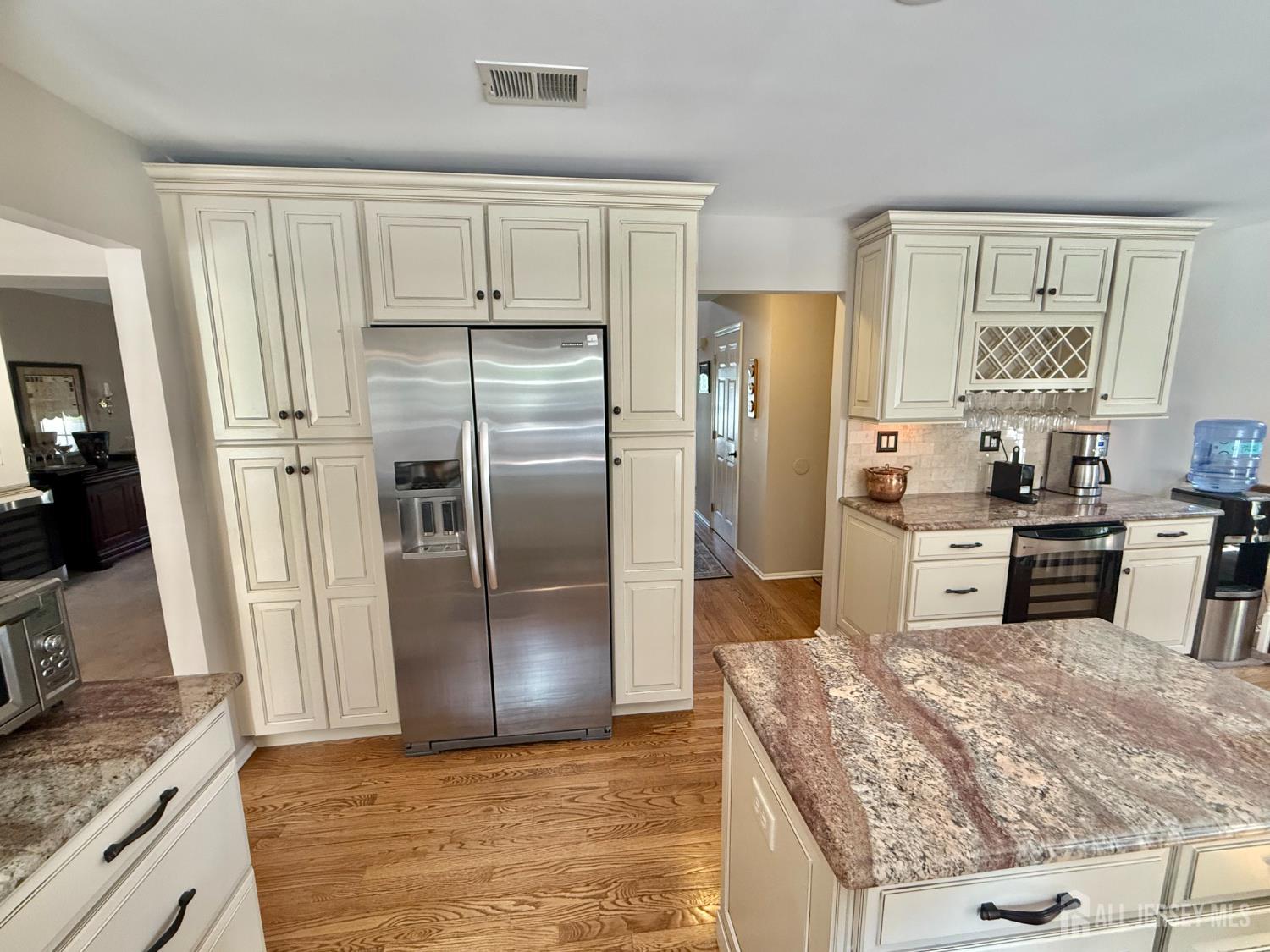 44 Diamond Lane Howell, NJ 07731 - Photo 7 of 35 a kitchen with granite countertop a refrigerator and a stove top oven